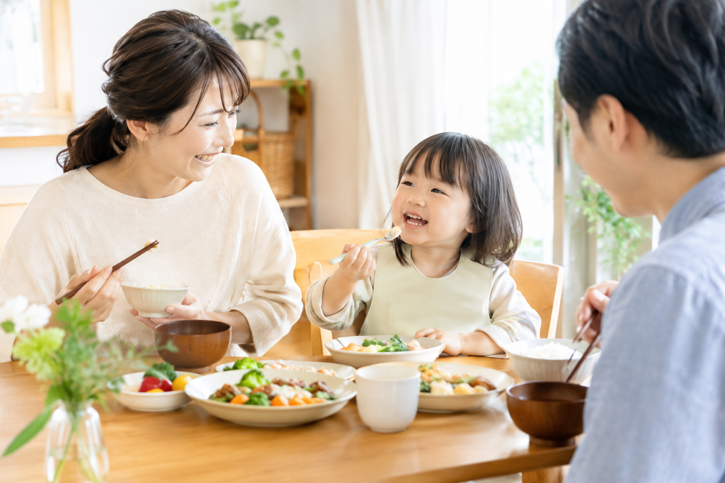 明るい食卓を囲み、一緒に食事を楽しむ親子